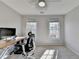 Bright bedroom featuring two windows, light gray walls, and modern desk at 3202 Monarch Pine Dr, Peachtree Corners, GA 30071