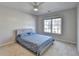 Bedroom with a ceiling fan, window for natural light, and neutral carpet at 3202 Monarch Pine Dr, Peachtree Corners, GA 30071