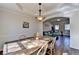 Charming dining room featuring hardwood floors, modern light fixtures, and a view into the cozy living room at 3202 Monarch Pine Dr, Peachtree Corners, GA 30071