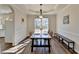 Bright dining room with a large window, wood floors, a modern light fixture, and seating for six at 3202 Monarch Pine Dr, Peachtree Corners, GA 30071