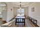 Bright dining room with a large window, wood floors, a modern light fixture, and seating for six at 3202 Monarch Pine Dr, Peachtree Corners, GA 30071