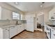 Well-lit kitchen with white cabinetry, granite countertops, stainless steel appliances, and hardwood floors at 3202 Monarch Pine Dr, Peachtree Corners, GA 30071