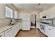 Modern kitchen featuring white cabinets, stainless steel appliances, granite countertops, and hardwood floors at 3202 Monarch Pine Dr, Peachtree Corners, GA 30071