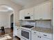 Well-appointed kitchen featuring white cabinetry, granite countertops, stainless steel appliances, and modern fixtures at 3202 Monarch Pine Dr, Peachtree Corners, GA 30071