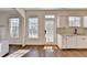 Sun-drenched kitchen features white cabinetry, granite counters, and backyard views at 3202 Monarch Pine Dr, Peachtree Corners, GA 30071