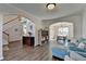 Spacious living room with hardwood floors connects seamlessly to the dining area and other living spaces at 3202 Monarch Pine Dr, Peachtree Corners, GA 30071