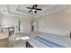 Spacious bedroom features a ceiling fan, tray ceiling, plush carpet, and natural light from the windows at 3202 Monarch Pine Dr, Peachtree Corners, GA 30071