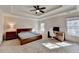 Serene main bedroom with tray ceiling, neutral decor, and home office setup at 3202 Monarch Pine Dr, Peachtree Corners, GA 30071