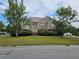 Charming brick two-story home with well-manicured lawn and mature trees at 3885 Laurens Ln, Snellville, GA 30039