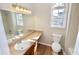 Bathroom with white sink, bath tub, tile, and wood look floors at 506 Summer Pl, Norcross, GA 30071