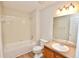 Bathroom with a white tub and shower, white tile, and wood look floors at 506 Summer Pl, Norcross, GA 30071