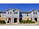 Charming townhouse with gray siding, brick accents, shutters and manicured landscaping at 506 Summer Pl, Norcross, GA 30071