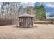 Charming gazebo set in a well-manicured lawn with lush landscaping at 506 Summer Pl, Norcross, GA 30071