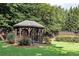 Charming gazebo set in a well-manicured lawn with lush landscaping at 506 Summer Pl, Norcross, GA 30071