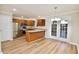 Open kitchen with stainless steel appliances, wood cabinets, and double french doors at 506 Summer Pl, Norcross, GA 30071