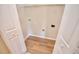 A compact laundry closet featuring durable wood flooring and practical wire shelving at 506 Summer Pl, Norcross, GA 30071