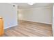 Bright living room with laminated wood flooring, white walls, and crown molding at 506 Summer Pl, Norcross, GA 30071