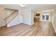 Open-concept living room with laminated floors flowing to the kitchen and staircase at 506 Summer Pl, Norcross, GA 30071