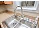 Close up on a stainless steel kitchen sink with modern faucet at 506 Summer Pl, Norcross, GA 30071