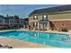 Inviting community swimming pool with lounge chairs surrounded by well-maintained apartment buildings at 506 Summer Pl, Norcross, GA 30071