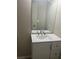 Bathroom vanity with white cabinet and drawers, a mirror, and a sink with modern faucet at 7054 Shenandoah Trl, Austell, GA 30168