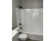 A bathroom with a tiled shower and bathtub combination has a black shower head and fixtures at 7054 Shenandoah Trl, Austell, GA 30168