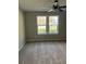 A bedroom with neutral walls and carpet features a ceiling fan and a double window providing natural light at 7054 Shenandoah Trl, Austell, GA 30168