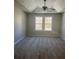 Carpeted bedroom featuring a tray ceiling with ceiling fan and double window with natural light at 7054 Shenandoah Trl, Austell, GA 30168