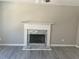 Living room featuring a white fireplace with marble surround and gray floors at 7054 Shenandoah Trl, Austell, GA 30168