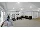 Finished basement with gym equipment, a TV and seating area at 910 Renaissance Way, Roswell, GA 30076