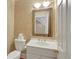 Cozy half-bath with a decorative mirror and white vanity at 910 Renaissance Way, Roswell, GA 30076