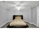 Cozy bedroom with neutral walls, soft carpet, and a bed featuring a sleek, dark frame at 910 Renaissance Way, Roswell, GA 30076