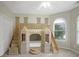 Unique bedroom featuring a castle themed bunk bed with stairs, slide and arched window at 910 Renaissance Way, Roswell, GA 30076