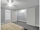 Relaxing bedroom featuring large, mirrored closets and soft, neutral carpet and walls at 910 Renaissance Way, Roswell, GA 30076