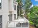 Overlooking lush greenery, this backyard deck offers a serene space for relaxation and outdoor entertainment at 910 Renaissance Way, Roswell, GA 30076