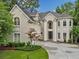 Charming exterior showcasing lush landscaping and a well-maintained driveway at 910 Renaissance Way, Roswell, GA 30076