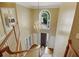 Bright foyer features hardwood floors, chandelier, and staircase with wooden banister, creating an elegant entry at 910 Renaissance Way, Roswell, GA 30076