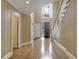 Bright foyer with hardwood floors and an open view to a staircase and chandelier at 910 Renaissance Way, Roswell, GA 30076