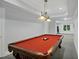 Finished basement with a billiard table and carpeted flooring at 910 Renaissance Way, Roswell, GA 30076