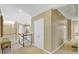 Hallway with neutral walls and trim is bright with doors leading to multiple rooms and levels at 910 Renaissance Way, Roswell, GA 30076