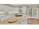 Bright kitchen with white cabinetry, granite countertops, and stainless steel appliances at 910 Renaissance Way, Roswell, GA 30076