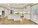 Bright and airy kitchen with white cabinets, granite counters, and stainless steel appliances at 910 Renaissance Way, Roswell, GA 30076