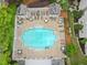 A sparkling pool offering a serene retreat, surrounded by lounge chairs, tables, and umbrellas at 910 Renaissance Way, Roswell, GA 30076