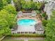 A refreshing pool area nestled within lush greenery and featuring lounge seating, perfect for relaxation at 910 Renaissance Way, Roswell, GA 30076