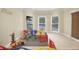 Bright playroom with bay windows, neutral walls, and colorful play equipment at 910 Renaissance Way, Roswell, GA 30076