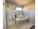 Modern bathroom with glass-enclosed shower and a soaking tub for relaxation at 1603 Maston Rd, Auburn, GA 30011