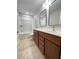 Bathroom featuring a double vanity, modern fixtures, and a tub with a shower at 1603 Maston Rd, Auburn, GA 30011