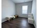 Clean bedroom with neutral tones, hardwood floors, and a window for natural light at 1603 Maston Rd, Auburn, GA 30011