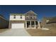 Two-story home with brick and siding exterior, two-car garage, and landscaped front yard at 1603 Maston Rd, Auburn, GA 30011