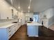 Modern kitchen featuring white cabinetry, a large center island, and stainless steel appliances at 1603 Maston Rd, Auburn, GA 30011